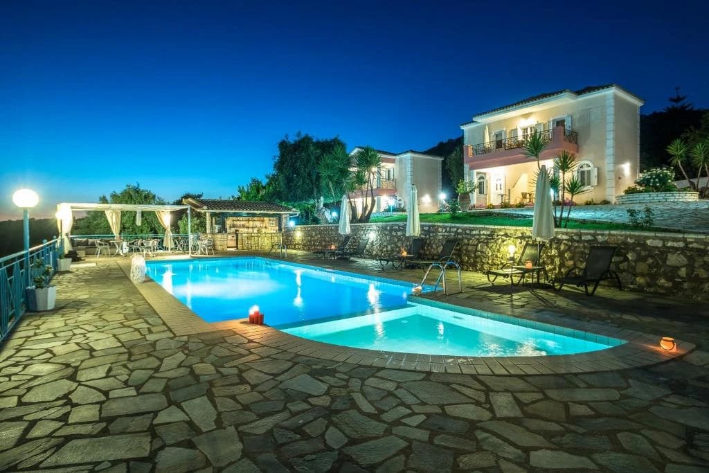 Swimming pool at night at Dallas Studios in Sivota, Greece