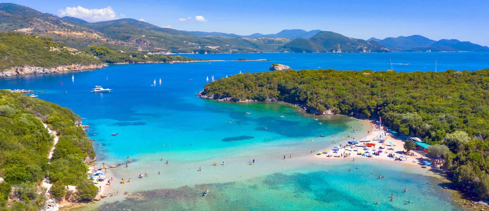 Aerial view of Bella Vraka Beach and Mourtemeno islet in Sivota, Greece
