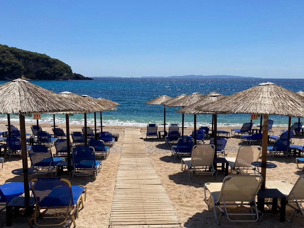 Mega Ammos Beach in Sivota with long sandy shore, clear blue water and organized facilities