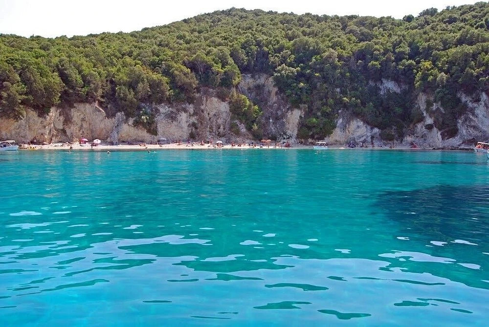 Pisina Beach in Sivota with crystal clear turquoise water and natural pool-like scenery accessible by boat